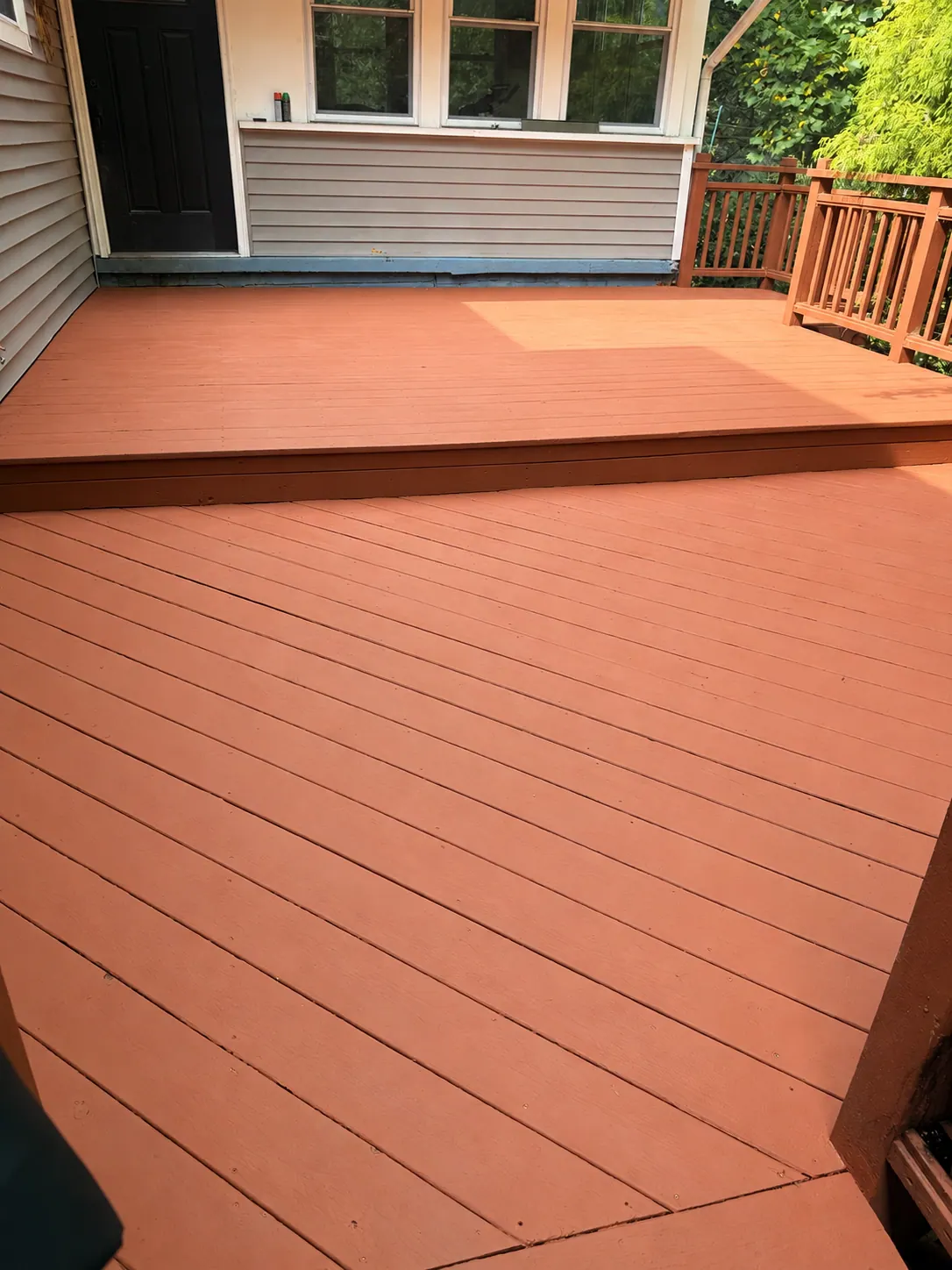 Red stained deck boards and railing